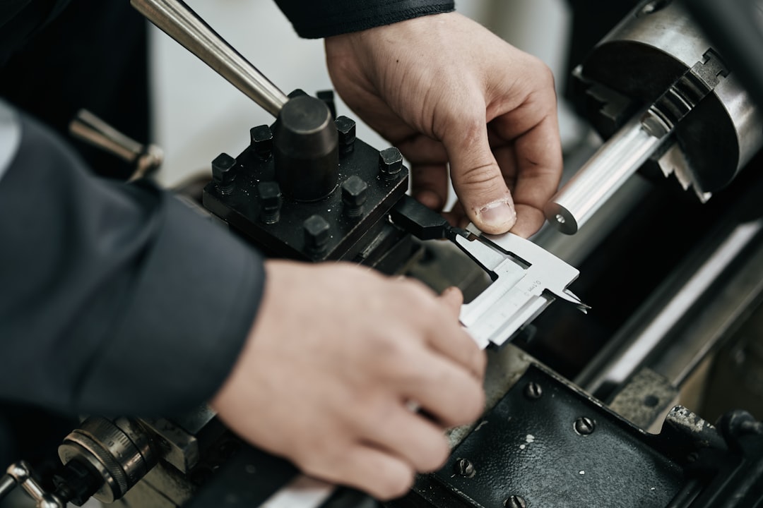 a-worker-measures-a-metal-rod-with-calipers-esujmhwbpls