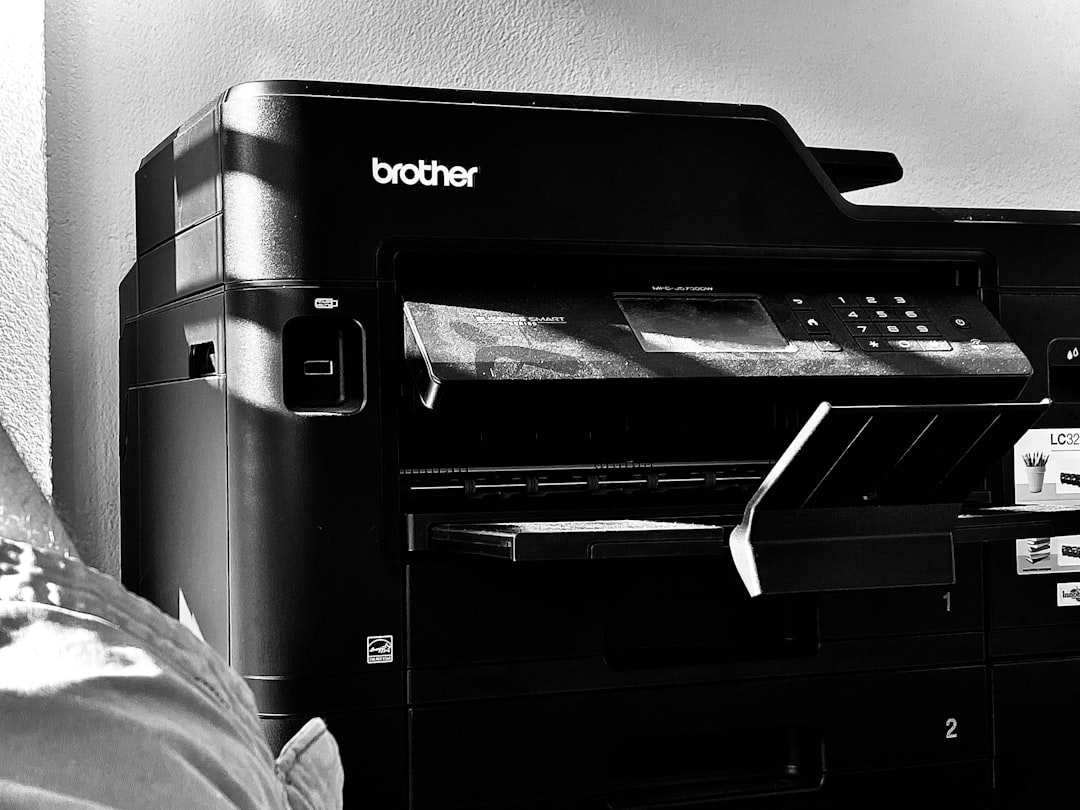 a-black-and-white-photo-of-a-printer-k-qozsncktg